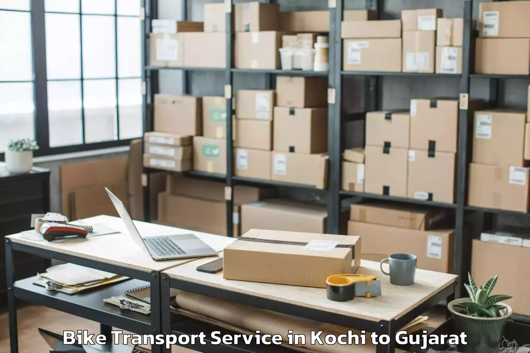 Book Kochi to Abhilashi University Rajkot Bike Transport Online